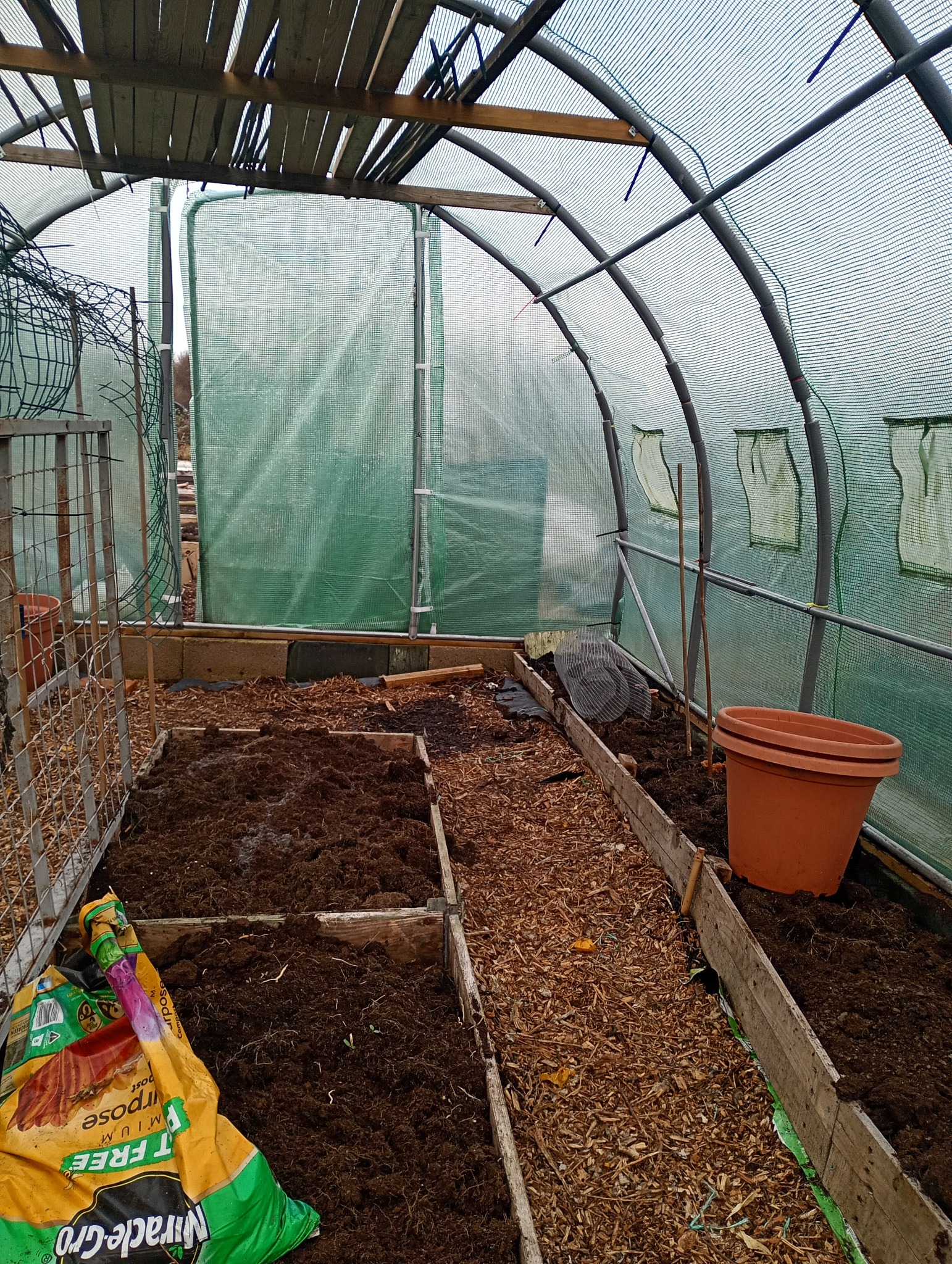 The inside of Dave's large polytunnel with prepared beds and woodchip paths ready for the growing season